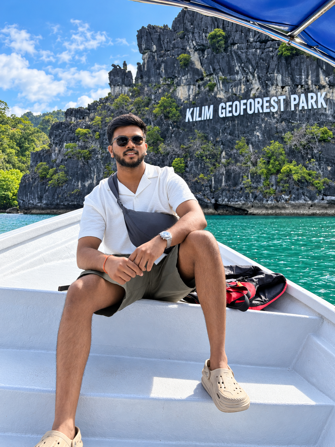 Parag sitting on a boat at Kilim Geoforest Park